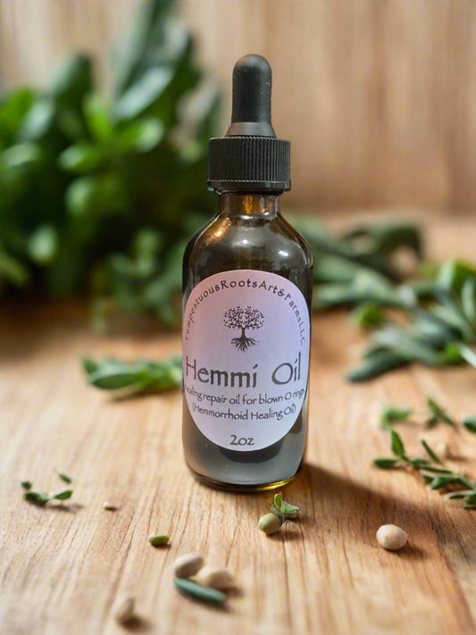 A bottle of hemorrhoid healing Hemmi Oil with a dropper on a wooden surface with green leaves in the background