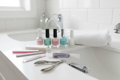 Nail Growth Support Oil "Get Nailed" by Tempestuous Roots on a white bathroom sink with manicure supplies